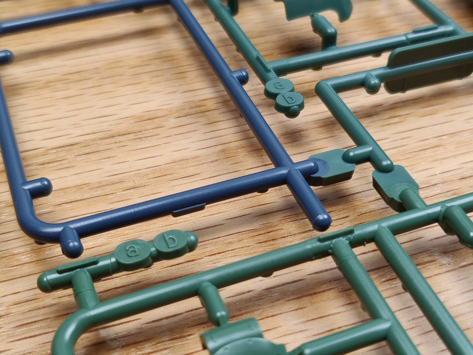 Single Real Grade Zaku II runner molded in several colors at once, grey, green and dark parts on one frame