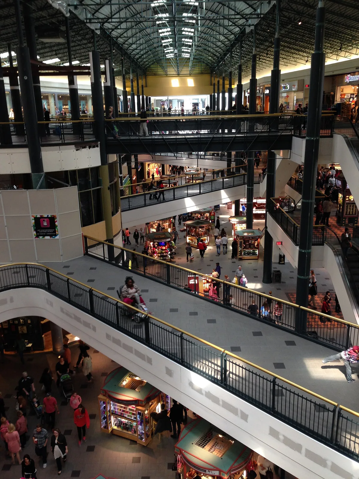 Three-level corridor inside the Mall of America in Bloomington, Minnesota, with walkways, kiosks and shoppers on each floor
