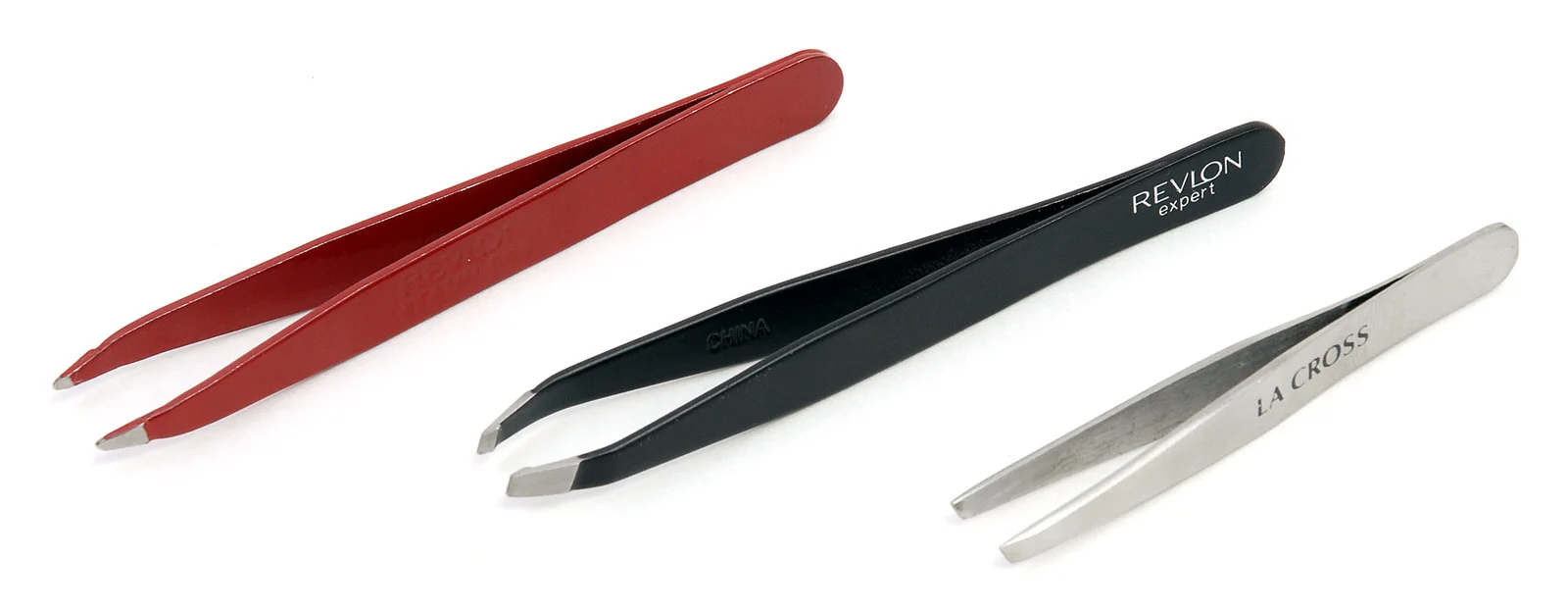 Three pairs of tweezers side by side: a red pair with slanted tips, a black pair with slanted tips and a silver pair with flat tips